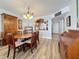 Dining area with wood table, chairs, built in storage, and an open layout to kitchen at 18304 Gulf Blvd # 217, Redington Shores, FL 33708