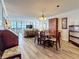 Open floor plan features a dining room, hardwood floors and a wall of windows at 18304 Gulf Blvd # 217, Redington Shores, FL 33708