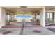 Inviting entrance area featuring stone flooring, columns, and beachfront views at 18304 Gulf Blvd # 217, Redington Shores, FL 33708