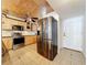 Bright kitchen boasts stainless steel appliances, wood cabinetry, and tiled flooring at 18304 Gulf Blvd # 217, Redington Shores, FL 33708