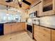 Bright kitchen featuring stainless steel appliances, tile floors and wooden cabinetry at 18304 Gulf Blvd # 217, Redington Shores, FL 33708