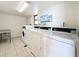 On-site laundry room featuring multiple commercial-grade washers and dryers for residents' use at 18304 Gulf Blvd # 217, Redington Shores, FL 33708