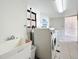 Community laundry room features a utility sink and multiple washers and dryers at 18304 Gulf Blvd # 217, Redington Shores, FL 33708