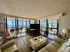 Relax in this light and bright living room with floor to ceiling windows and patio access at 18304 Gulf Blvd # 217, Redington Shores, FL 33708
