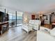 Inviting living room with hardwood floors, white sofas, and sliding glass doors to balcony at 18304 Gulf Blvd # 217, Redington Shores, FL 33708