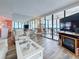 Bright living room featuring white furniture, fireplace, and a balcony with ocean views at 18304 Gulf Blvd # 217, Redington Shores, FL 33708