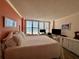 Cozy bedroom featuring a large bed, dressers, and windows with shutters offering Gulf views at 18304 Gulf Blvd # 217, Redington Shores, FL 33708