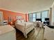 This large bedroom offers plenty of natural light and a view of the ocean from the floor-to-ceiling windows at 18304 Gulf Blvd # 217, Redington Shores, FL 33708