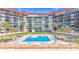 Beautiful beachfront complex, featuring a pool, sundeck, palm trees, and beach access at 18304 Gulf Blvd # 217, Redington Shores, FL 33708