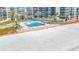 Aerial photo of pool and lounge area on a white sandy beach, showing building amenities at 18304 Gulf Blvd # 217, Redington Shores, FL 33708