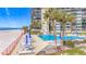 View of the pool and beach from condo, showing beach access and lounge area at 18304 Gulf Blvd # 217, Redington Shores, FL 33708