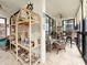 Inviting sunroom with tiled floor, fan, seating and large windows allowing views to beach at 18304 Gulf Blvd # 217, Redington Shores, FL 33708