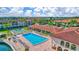 Aerial view of a community pool, lounge chairs and manicured landscaping at 19029 Us Highway 19 N # 8-15, Clearwater, FL 33764