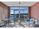 Enclosed balcony featuring outdoor seating and serene waterfront views through sliding glass doors at 19029 Us Highway 19 N # 8-15, Clearwater, FL 33764