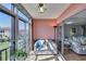 Sunroom offers relaxing seating and water view through large glass windows and sliding door at 19029 Us Highway 19 N # 8-15, Clearwater, FL 33764