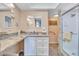 Modern bathroom with granite countertop, white cabinets, and accessible walk-in shower at 19029 Us Highway 19 N # 8-15, Clearwater, FL 33764