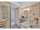 Bright bathroom with granite countertop vanity, decorative mirror, and coastal decor at 19029 Us Highway 19 N # 8-15, Clearwater, FL 33764