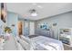 Calm bedroom with blue walls, coordinating dresser, and comfortable bed with bright white linens at 19029 Us Highway 19 N # 8-15, Clearwater, FL 33764