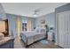 Well-lit bedroom featuring soft blue accents, comfy bed, and lots of natural light at 19029 Us Highway 19 N # 8-15, Clearwater, FL 33764