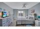 Cozy bedroom featuring light blue walls, a waterfront view, and soft, patterned bedding at 19029 Us Highway 19 N # 8-15, Clearwater, FL 33764