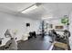 Well-equipped exercise room with various machines, a TV, and bright lighting for convenient workouts at 19029 Us Highway 19 N # 8-15, Clearwater, FL 33764