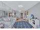 Bright living room with a large wall mirror, round anchor rug, and relaxing furniture at 19029 Us Highway 19 N # 8-15, Clearwater, FL 33764