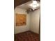 Small bedroom with boarded window and damaged ceiling with hanging debris at 3201 N 15Th St, Tampa, FL 33605