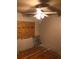 Bedroom with wood-look floors and barred window with ceiling fan at 3201 N 15Th St, Tampa, FL 33605