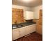 Kitchen featuring a stainless steel sink, white cabinets and green countertop at 3201 N 15Th St, Tampa, FL 33605
