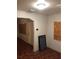 Unfurnished living room featuring wood-look floors and access to front door at 3201 N 15Th St, Tampa, FL 33605