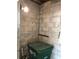 Cinderblock room with exposed lightbulb, and a green trash can sitting in the corner at 3201 N 15Th St, Tampa, FL 33605