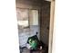 Unfinished room with cinder block walls, a boarded window, and miscellaneous items scattered on the floor at 3201 N 15Th St, Tampa, FL 33605