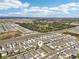 Aerial view of a residential community with lakes, ponds, and mature landscaping at 32231 Conchshell Sail St, Wesley Chapel, FL 33545