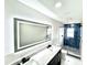 Bathroom features a double sink vanity with blue-tiled shower and glass door at 3735 69Th N Way, St Petersburg, FL 33710
