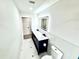 Bathroom features a double sink vanity with a marble countertop and modern fixtures at 3735 69Th N Way, St Petersburg, FL 33710