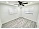 Bright bedroom features a ceiling fan, hardwood floors, white trim and windows at 3735 69Th N Way, St Petersburg, FL 33710
