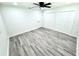Bright bedroom features a ceiling fan, hardwood floors and a wall of closet space at 3735 69Th N Way, St Petersburg, FL 33710