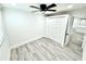 Bedroom features light wood floors, neutral walls, ceiling fan, and closet at 3735 69Th N Way, St Petersburg, FL 33710