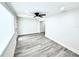 Bright bedroom featuring wood flooring, white walls and ceilings, and a black ceiling fan at 3735 69Th N Way, St Petersburg, FL 33710