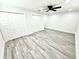 Generously sized bedroom with wood flooring, white walls, ceiling fan, and dual closets at 3735 69Th N Way, St Petersburg, FL 33710
