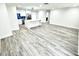 Spacious open-concept living area with wood flooring, and recessed lighting adjacent to the modern kitchen at 3735 69Th N Way, St Petersburg, FL 33710