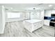 Bright living room features an open floor plan with a modern kitchen island at 3735 69Th N Way, St Petersburg, FL 33710