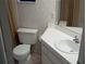 Bathroom with a sink, toilet, tile floor, and shower with curtain at 375 Woods Landing Trl, Oldsmar, FL 34677