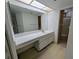 Bathroom with a large mirror, vanity with sink and walk-in shower at 375 Woods Landing Trl, Oldsmar, FL 34677