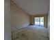 Bedroom featuring vaulted ceiling, neutral wallpaper and a door to the outside at 375 Woods Landing Trl, Oldsmar, FL 34677
