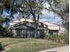 Exterior view of a well-maintained two-story home with tidy landscaping and healthy green grass at 375 Woods Landing Trl, Oldsmar, FL 34677