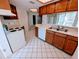 The kitchen features tile floor, white appliances, and ample countertop space at 375 Woods Landing Trl, Oldsmar, FL 34677