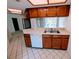 The kitchen features tile floor, white appliances, and wood cabinets at 375 Woods Landing Trl, Oldsmar, FL 34677