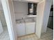 Laundry closet with washer, dryer, water heater and a shelf for storage at 375 Woods Landing Trl, Oldsmar, FL 34677