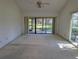 A spacious living room area leads out to the enclosed back patio at 375 Woods Landing Trl, Oldsmar, FL 34677